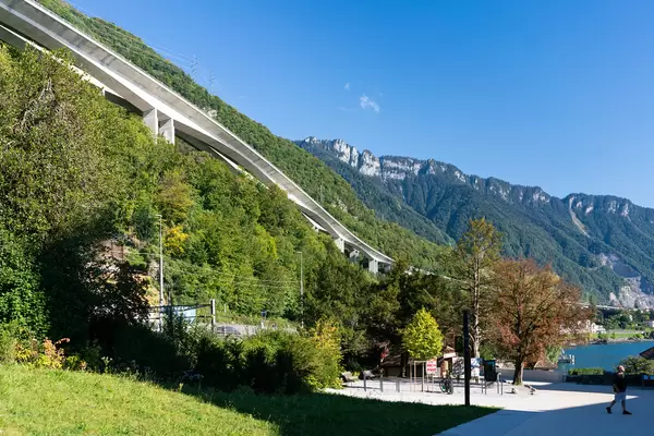 White highway concrete beautiful bridge built in the side of the hill next to lake Geneva