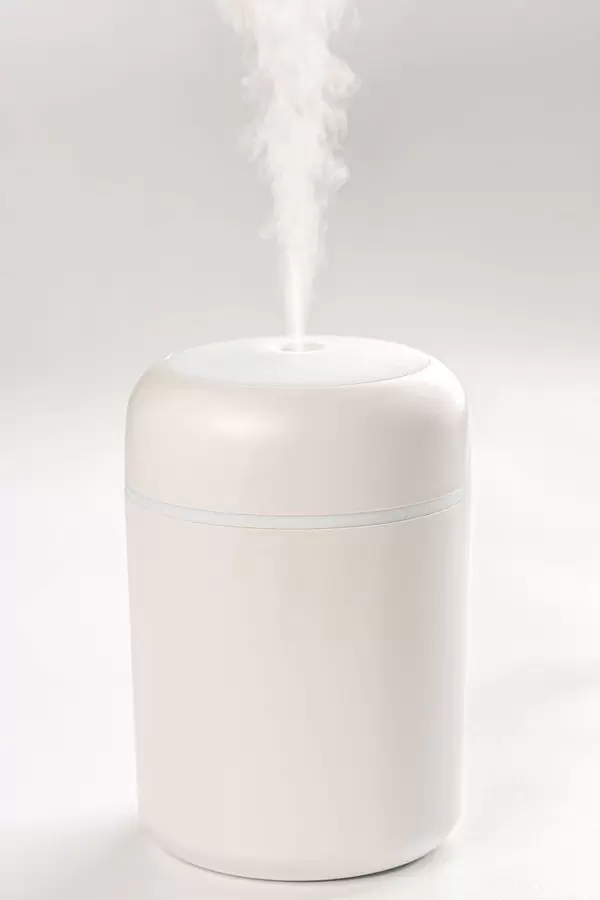 White humidifier with escaping steam