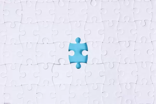 White jigsaw puzzle with missing piece