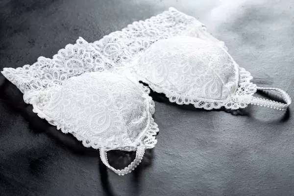 White lace bra on dark background (Flip 2019)