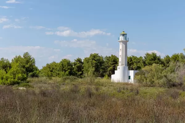White lighthouse close to the beach