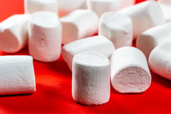 White marshmallow close-up on red background