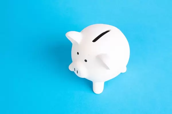 White piggy bank on blue background