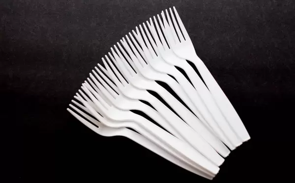 White Plastic Forks on a Black Background