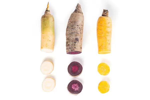 White, purple and yellow carrots, sliced