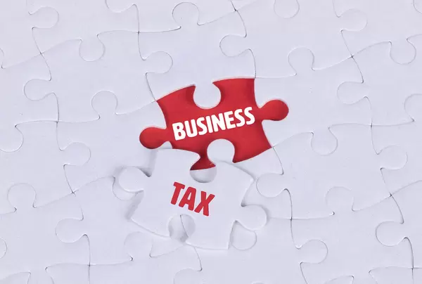 White puzzle with word Business & Tax