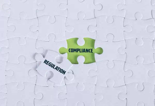 White puzzle with word Compliance & Regulation