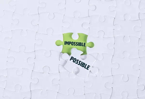 White puzzle with word Impossible & Possible