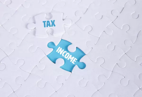 White puzzle with word Tax & Income