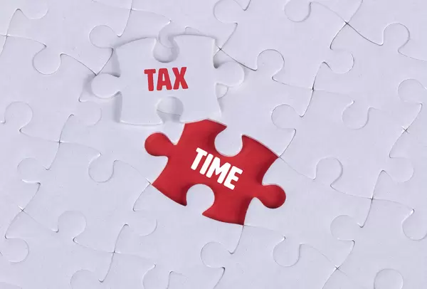 White puzzle with word Tax & Time