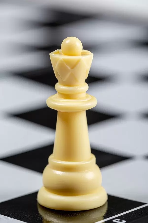 White Queen on the background of an empty chessboard