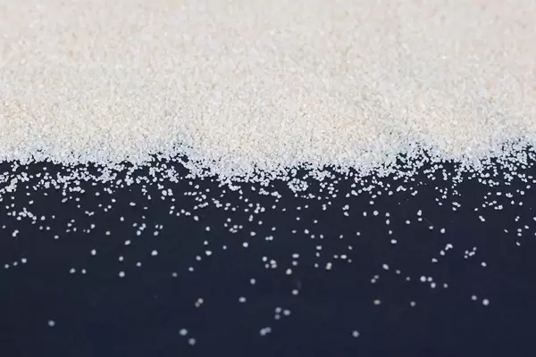 White sand on black background