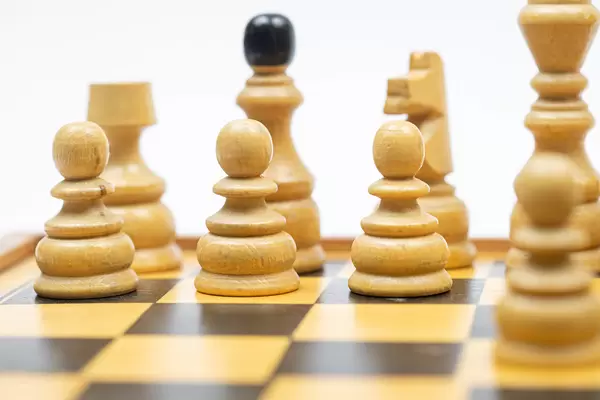 White wooden Chess figures on the chess board