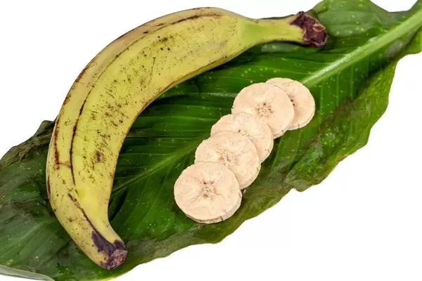 Whole and pieces of plantain on a green leaf