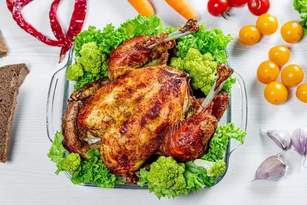 Whole baked chicken with vegetables and spices.Top view (Flip 2019)