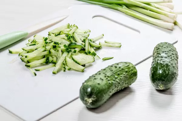 Whole fresh cucumbers and sliced on the kitchen Board. The concept of cooking (Flip 2019)