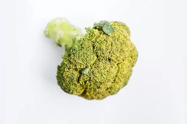 Whole head of broccoli on white background