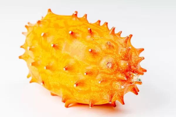 Whole orange kiwano fruit on white background (Flip 2020)