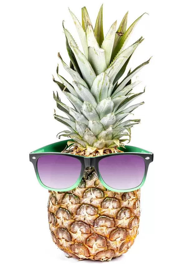 Whole raw fresh pineapple with sunglasses on white background. Summertime holiday concept (Flip 2020)