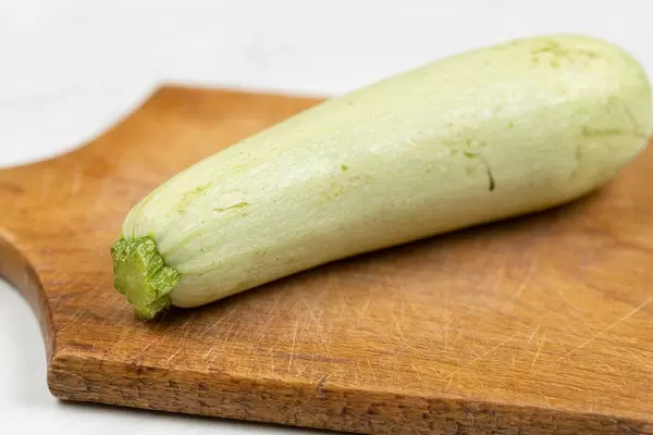 Whole Raw Zucchini on the wooden cutting board