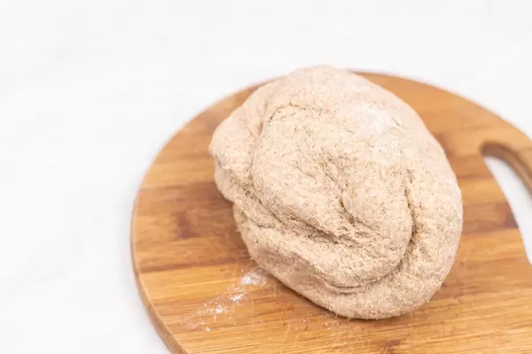Whole wheat flour dough on the wooden board