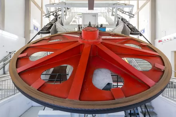 Wie die Seilbahn auf Santorin funktioniert: ein Detail vom großen roten Rad in Firá