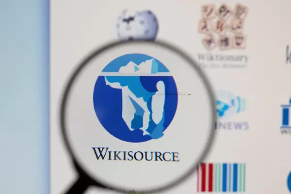 Wikisource logo on a computer screen with a magnifying glass