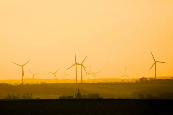 Wind turbines skyline, orange sunset