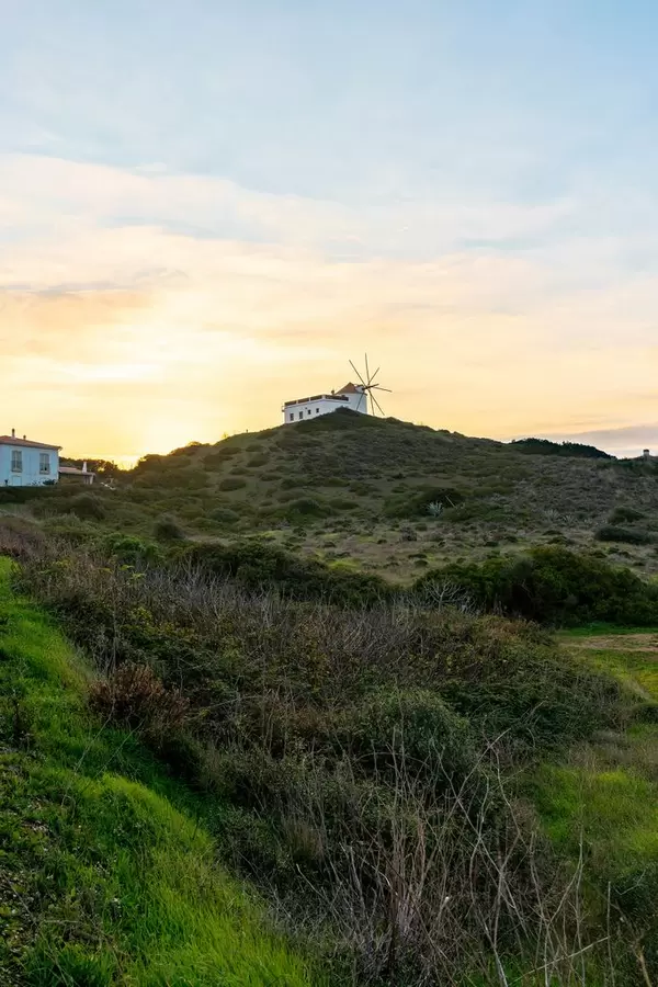 Windmill on the top of the hill during glorious sunset