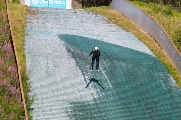 Winter sportsman trains ski jumping in summer at the ski jumping facility of Lahti, Finland