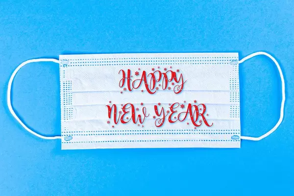 Wish a Happy New Year on a medical mask, blue background