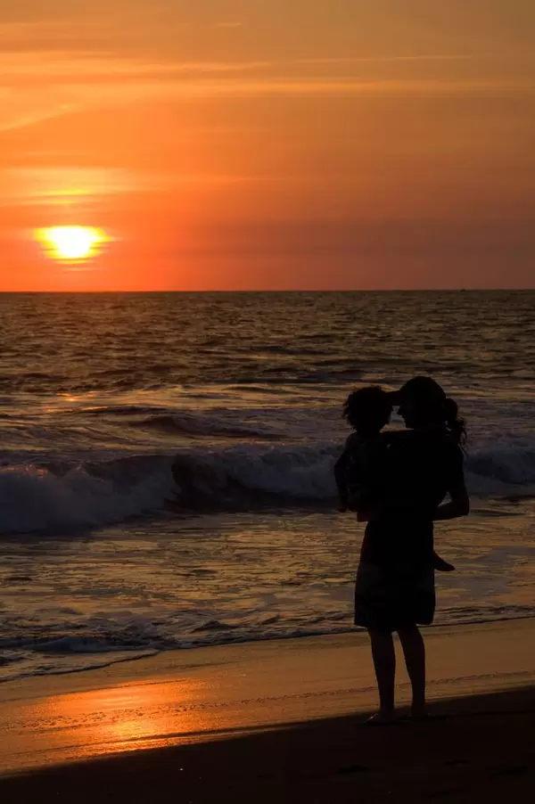 Woman and child enjoying sunset