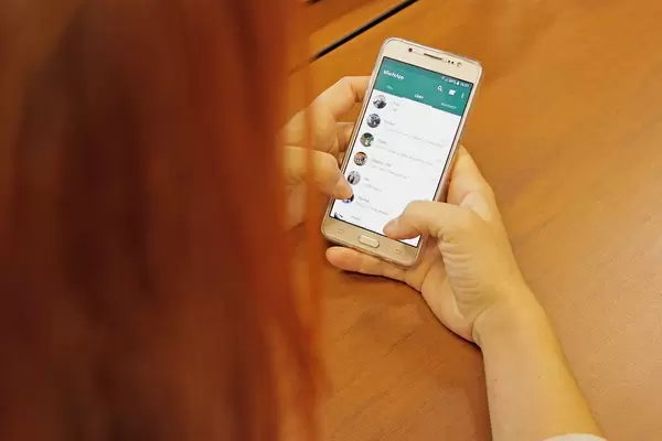 Woman chats on Whatsapp with a Samsung smartphone