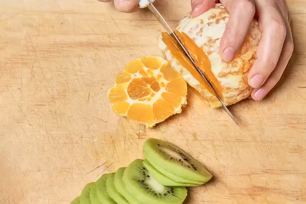 Woman cutting grapefruit