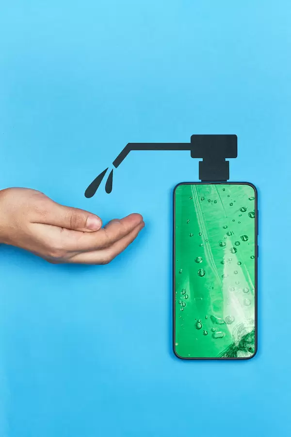 Woman disinfecting hand with mobile hand sanitizer