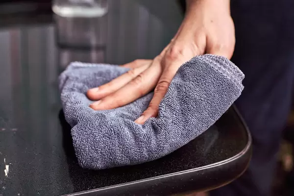 Woman disinfecting surfaces from bacteria or viruses