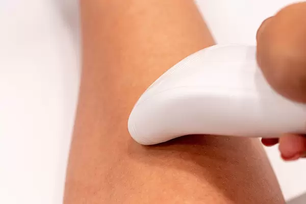 Woman doing hair removal with an electric epilator (Flip 2019) (Flip 2019)
