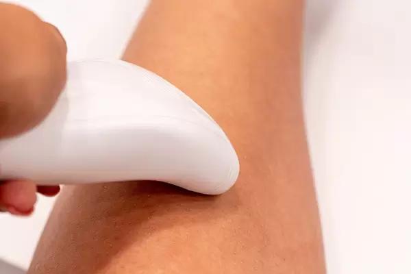Woman doing hair removal with an electric epilator