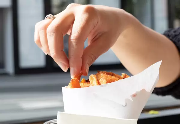 Woman eating french fries