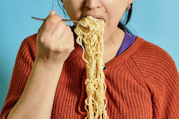 Woman eating noodles