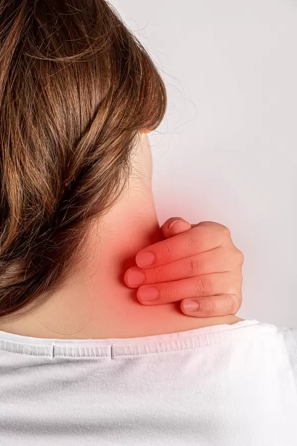 Woman experiencing pain in the cervical spine, healthcare concept