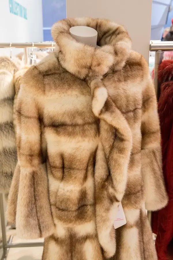 Woman fur coat in a store