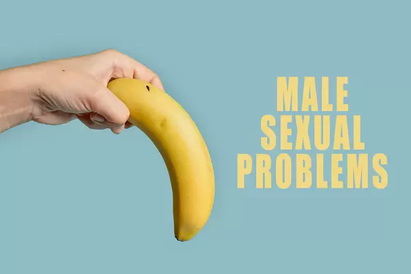 Woman hand holds banana tilted down, symbol of erectile dysfunction, male impotence or male sexual problems