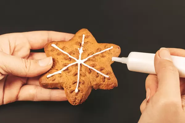 Woman hands holding homemade gingerbread cookies, close up