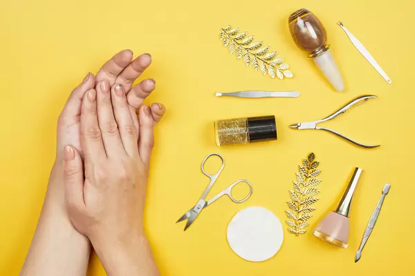 Woman hands near a set of professional manicure tools. Beauty care