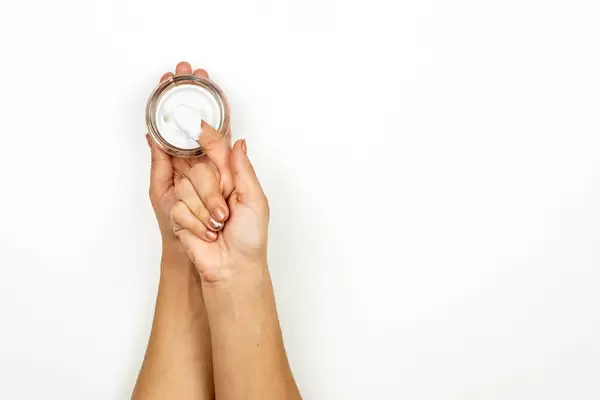 Woman holding jar of winter cream for skin
