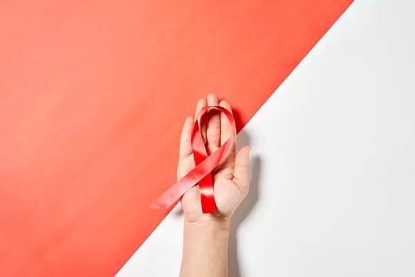 Woman holds cancer awareness ribbon
