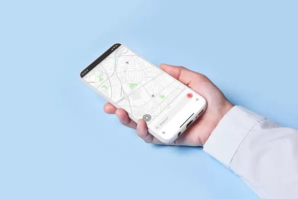 Woman holds smartphone with location map