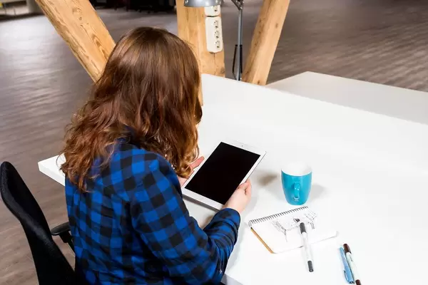 Woman in a Co-working space with her tablet