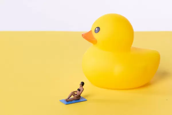 Woman in bathing suit with yellow rubber duck